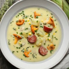 a white bowl filled with soup on top of a wooden table