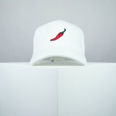 Chilli cotton twill baseball cap with a red, green & black embroidered design. Top your look with Hatty Hats Embroidery embroidered baseball caps. Embroidered with love <3 in the United Kingdom. ♥ Baseball cap with chilli embroidered design. ♥ One size fits all unisex hat with adjustable strap at rear. ♥ 100% Cotton twill fabric. ♥ Hat colour available in: Grey / Green / White / Black / Red / Beige / Blue / Navy / Olive Green / Burgundy. ♥ Designed by & exclusive to Hatty Hats Embroidery. ♥ Embroidered in the United Kingdom. View our full assortment of hats here - https://www.etsy.com/uk/shop/HattyHatsEmbroidery 🚚🌎 Free UK shipping on all orders + Free worldwide shipping on orders over $35 / £35 Embroidered White Baseball Cap For Streetwear, White Embroidered Baseball Cap For Streetwear, White Embroidered Cotton Baseball Cap, White Cotton Fitted Hat With Curved Bill, Streetwear Cotton Hat With Embroidered Patch, Cotton Streetwear Hat With Embroidered Patch, Cotton Baseball Cap With Embroidered Patch, Embroidered Curved Brim Baseball Cap For Streetwear, Cotton Trucker Hat With Embroidered Patch And Curved Bill