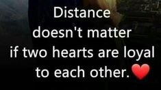 a man standing in front of a window with the words distance doesn't matter if two hearts are loyal to each other