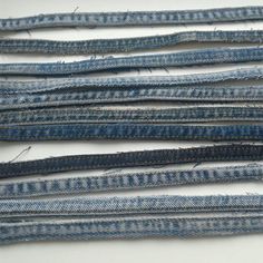 several pieces of blue jean fabric laid on top of each other with holes in them