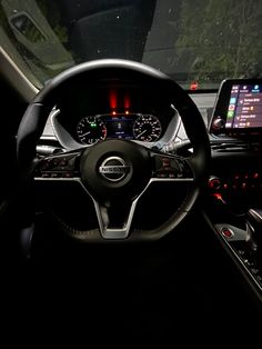 the interior of a car with dashboard lights and steering wheel, including an electronic display