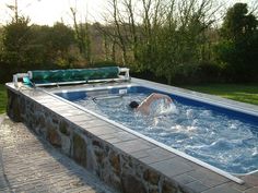 a man is swimming in an outdoor hot tub