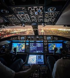 two pilots are in the cockpit of an airplane with multiple screens on each side of them