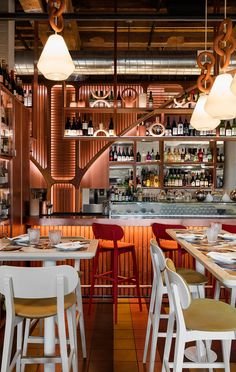 the interior of a restaurant with wooden tables and chairs