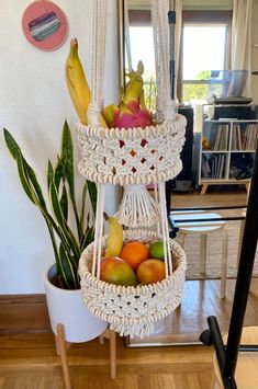 there is a fruit basket hanging from the wall