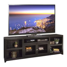 a flat screen tv sitting on top of a wooden entertainment center