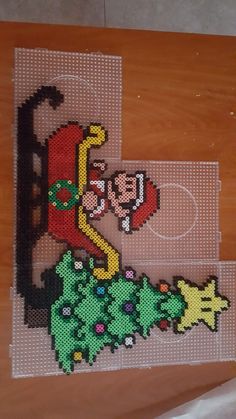 an image of a cross stitch pattern on a piece of wood that has been made to look like a cartoon character