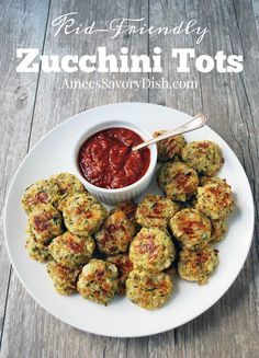 zucchini tots on a white plate with ketchup in a small bowl