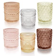 four different colored glass cups sitting next to each other