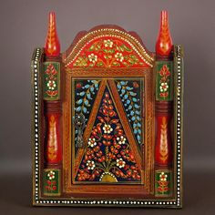 an ornate wooden box with colorful designs on it