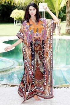 Want to shop for a dress that is comfortable, classy and elegant at the same time? Then this alluring Silk Kaftan dress with glittering crystal work is the best choice for you. The minimal V neckline sets a perfect combination with sassy sidelines of the silk Kaftan dress. The beauty of brown shade is more evident with tinge of orange, maroon, black and white. Swim wear kaftan Style it with white earrings and white heels for a relaxing day at beach. ONE SIZE FIT ALL KAFTAN ( Small to 8XL) Materi Festive V-neck Printed Kaftan, Multicolor V-neck Dress For Eid, Flowy V-neck Dresses For Eid, Bohemian Long Dress For Eid, Elegant V-neck Kaftan For Festivals, Printed V-neck Dress For Eid, Long Summer Dresses In Bollywood Style, Bollywood Style Long Summer Dresses, Long Bollywood Summer Dresses