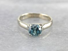 This style of ring is timeless, and suited to so many occasions! Small enough in profile to wear every day, it has enough glitter and color to stand out on its own as a cocktail ring! The blue zircon in this piece is particularly fine, a true, teal blue that brings to mind the color of the caribbean ocean. Metal: 14K White Gold Gem: Blue Zircon 2.08 Carats Gem Measurements: 7.1 mm, Round Ring Size: 7.50 Marks: "14K SS" Stamped on the inside band White Gold Rings Simple, Gold Ring Simple, Blue Zircon Ring, Caribbean Ocean, Gold Rings Simple, Ring Simple, Ring Blue, Zircon Ring, Round Rings