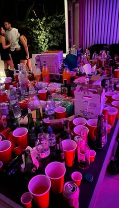 a table with many cups and bottles on it