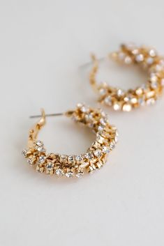 Elevate your evening with the help of the Bianca Gold Rhinestone Hoop Earrings! These chic earrings feature a lever back with a rhinestone hoop design. Style the Bianca Earrings with anything from dresses to denim for an elevated look! Gold Plated Hoop Rhinestones Lever Back One Size | Length 1” Hoop Earrings With Sparkling Crystal Stones, Small Hoop Earrings With Sparkling Stones For Party, Sparkling Stones Small Hoop Earrings For Party, Sparkling Hoop Crystal Earrings, Sparkling Crystal Hoop Earrings, Sparkling Hoop Crystal Earrings For Wedding, Small Hoop Crystal Earrings, Small Hoop Earrings With Rhinestones, Small Crystal Hoop Earrings For Party