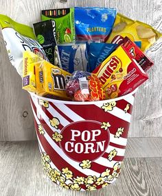 a popcorn bucket filled with candy and snacks