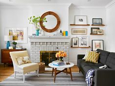 a living room filled with furniture and a fire place in front of a white fireplace