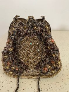 Beautifully beaded shoulder bag by Vanessa, in outstanding condition. Measures 6" by 2 1/2" across the bottom. stands 6" tall, chain for shoulder is 21" long. Wonderful Bride's Bag! Free Shipping! Handheld Beaded Clutch, Bohemian Embellished Bags For Formal Occasions, Bohemian Beaded Evening Clutch, Bohemian Embellished Formal Bags, Evening Brown Beaded Shoulder Bag, Beaded Evening Shoulder Bag, Beaded Shoulder Bag Clutch, Bohemian Beaded Gold Clutch, Formal Beaded Shoulder Bag