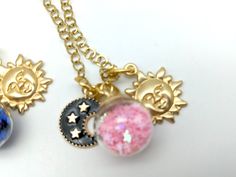 "A made to order sun, moon and stars charm pendant necklace with your choice of star and moon colors. Sturdy 5 mm cable chain with a rhinestone accent on the end can be adjusted up to 20\" Charms range from 15-20 mm Want a different length? Let us know what you need at checkout. Shorter lengths are at no cost. Longer chains may incur an additional charge. US SHIPPING: US orders over $35 or for 3 or more items ship free via first class mail. Orders over $150 receive a free priority mail upgrade. Whimsical Star Charm Jewelry As Gift, Whimsical Star Charm Jewelry Gift, Whimsical Gold Moon Jewelry, Whimsical Moon-shaped Gold Jewelry, Celestial Charm Necklace With Star Charm And Round Pendant, Celestial Charm Necklaces As Gift, Celestial Charm Necklace As A Gift, Celestial Charm Necklace For Gift, Celestial Charm Necklace With Round Pendant