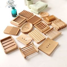 wooden utensils are arranged on a white surface