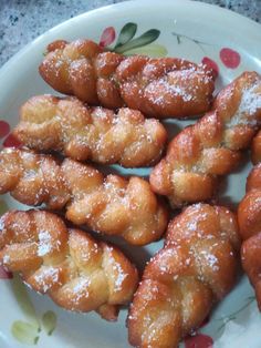 small pastries on a plate with powdered sugar