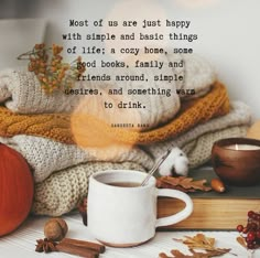 a cup of coffee sitting on top of a table next to a pile of books