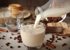 a glass filled with milk being poured into it