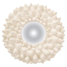 a white circular object with lots of bubbles on it