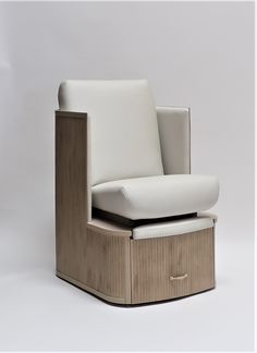 a white chair sitting on top of a wooden box