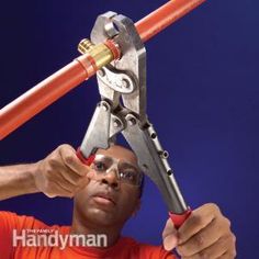 a man holding a pair of pliers over his head