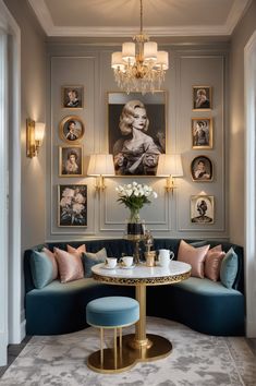 a living room with blue couches and pictures on the wall above it, along with a round coffee table