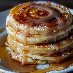 a stack of pancakes covered in caramel syrup