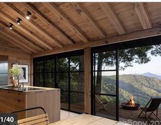 an open kitchen and dining area with a view over the mountains to the valley below