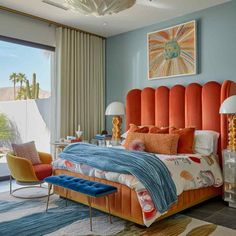 a bedroom with an orange headboard and blue walls