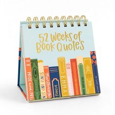 a notebook with the words 52 weeks of book quotes on it and colorful books lined up in rows