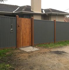 a wooden gate in front of a house