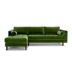 a green couch and footstool sitting next to each other on a white background