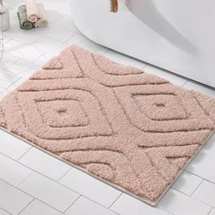 a bathroom rug that is on the floor in front of a bathtub and toilet