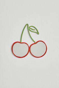 a pair of cherries with red frames and green leaves on the top, against a white background