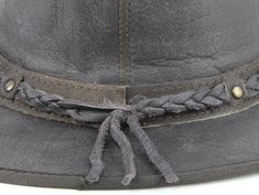 Our smooth leather cowboy hats are made of genuine cowhide leather. This beautifully handcrafted hat is made with fine craftsmanship and materials. Any scars, wrinkles or other subtle variations are characteristics of natural leather and do not affect its strength or quality. The unisex leather hat is embellished with brass conchos. The crown of the had also boasts a braided hat band. Use the strap for windy days or to keep it around your neck while traveling so you won't lose it. Another great Casual Leather Fedora For Rodeo, Brown Braided Hat For Rodeo, Rustic Leather Fedora With Adjustable Fit, Adjustable Leather Country Fedora, Casual Leather Hat Bands For Rodeo, Festival Leather Hat Bands In Brown, Country Style Leather Fedora, Country Style Brown Hat Band With Leather Sweatband, Leather Adjustable Fedora For Ranch