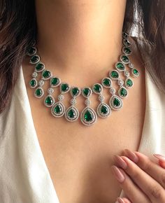 Adorn yourself in resplendent elegance with our Emerald green CZ Necklace Set, a dazzling fusion of sophistication and allure.   Encased in a lustrous setting, each crystal reflects light with mesmerizing brilliance, ensuring all eyes are drawn to its radiant beauty.  Perfect for weddings or any special occasion, this Indian-inspired statement necklace exudes timeless charm and grace, making every moment a cherished memory. Elevate your ensemble and enchant onlookers with this enchanting American Diamond Necklace, a testament to refined taste and elegance  Necklace length-15 inches  Width-8.5"  Adjustable length Necklace Closure: Hook Earrings length :1.5" Each earring weighs 5gms Earrings Closure: Pushback Diamond Necklace Indian, Radiant Beauty, American Diamond Necklaces, Necklace Indian, Indian Necklace, Indian Jewelry Sets, Bollywood Jewelry, Pakistani Jewelry, Indian Inspired