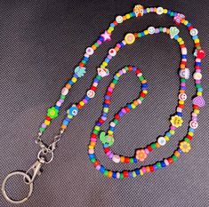 Adorable, fun, colorful lanyard. Perfect for teachers, nurses, or anyone looking for a colorful addition to their day. Multicolor Handmade Craft Supplies For School, Handmade Multicolor Craft Supplies For School, Fun Multicolor Lanyards For Gifts, Fun Multicolor Lanyards As Gifts, Multicolor Lanyards With Key Leash, Multicolor Lanyards With Round Beads And Key Leash, Multicolor Beaded Lanyard With Key Leash, Handmade Adjustable Multicolor Lanyards, Fun Multicolor Craft Supplies For Hobby