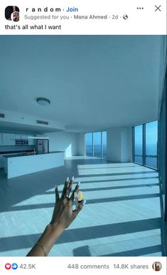 someone is holding their hand up to take a photo in the middle of an empty room