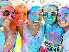 four girls are covered in colored powder with the words 10 reasons you should do the color run