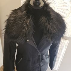 This Jacket Is Absolutely Gorgeous!!! It Is A Size Small, But It Is Oversized For Layering, So It Will Fit In Medium As Well. It Is Fully Lined. It Has Elastic Cording Adjusters On The Bottom Of Both Sides, So You Can Make It Fit Tighter Around The Bottom. It Has An Inside Pocket As Well.This Is The Ultimate Snow Bunny Jacket! Please See Photos For Description And Details. Please Ask If You Have Any Additional Questions. I Do Not Trade. Thank You. Black Parka With Faux Fur Trim For Winter, Winter Black Parka With Faux Fur Trim, Black Fur Coat With Padded Collar, Black Fur Coat With Padded Collar For Fall, Luxury Fall Parka With Faux Fur Trim, Black Parka With Faux Fur Lining For Cold Weather, Luxury Fall Parka With Faux Fur Lining, Black Outerwear With Faux Fur Trim For Cold Weather, Black Outerwear With Faux Fur Lining For Cold Weather