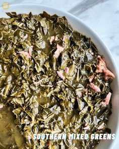 collard greens in a white bowl on a marble counter top with the words southern mixed greens