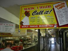 a restaurant with signs hanging from the ceiling