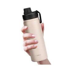 a woman's hand holding a tan insulated water bottle