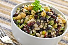 a white bowl filled with beans and vegetables