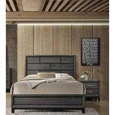 a bedroom with a bed, dresser and night stand in the middle of the room