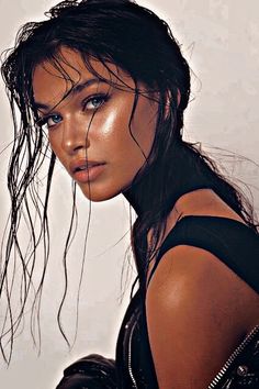 a woman with wet hair is posing for the camera